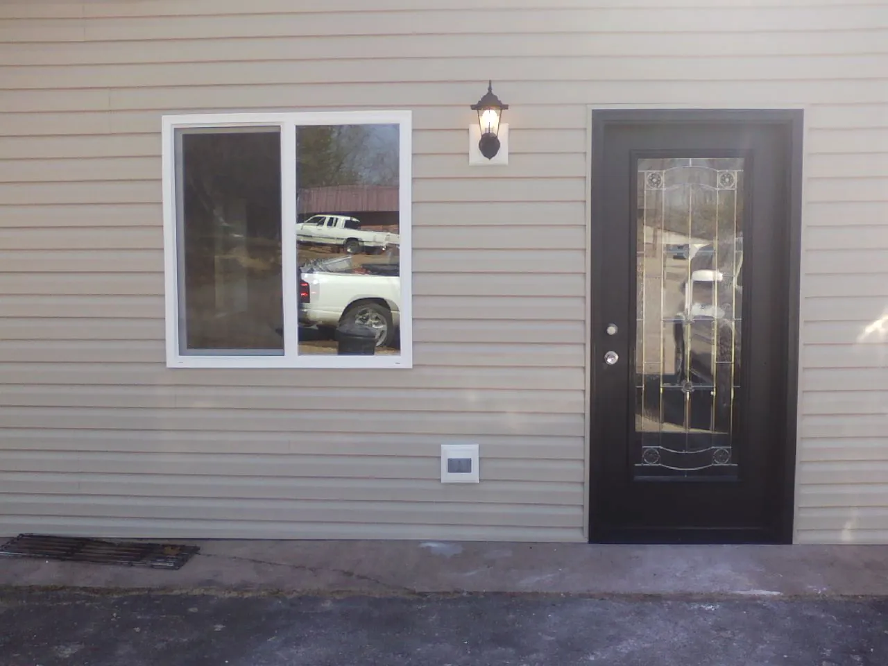 New siding, window and entry door on the side of an addition in Avondale